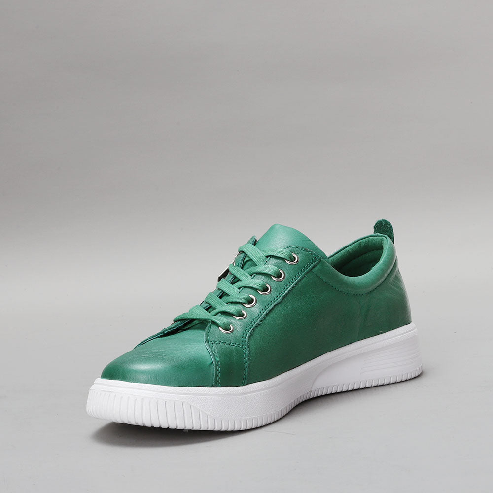 Naked Arches Nelly Jade sneakers with green and beige colorway, featuring a casual slip-on design and stylish arch support.