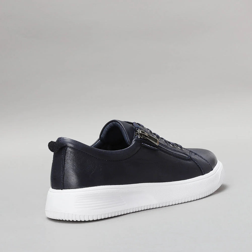 Naked Arches Nelly navy sneakers with white sole and lace-up design, showcasing a casual, comfortable footwear style.