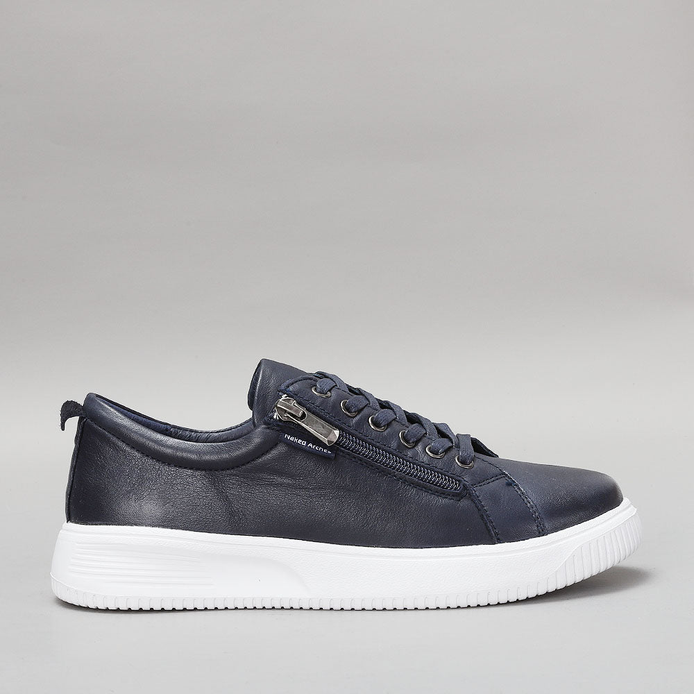 Naked Arches Nelly Navy sneakers with navy blue fabric and white sole, displayed from a side view.