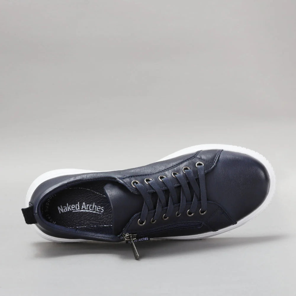 Naked Arches Nelly Navy sneakers featuring navy blue fabric and white sole, casual slip-on style with stylish arch support.