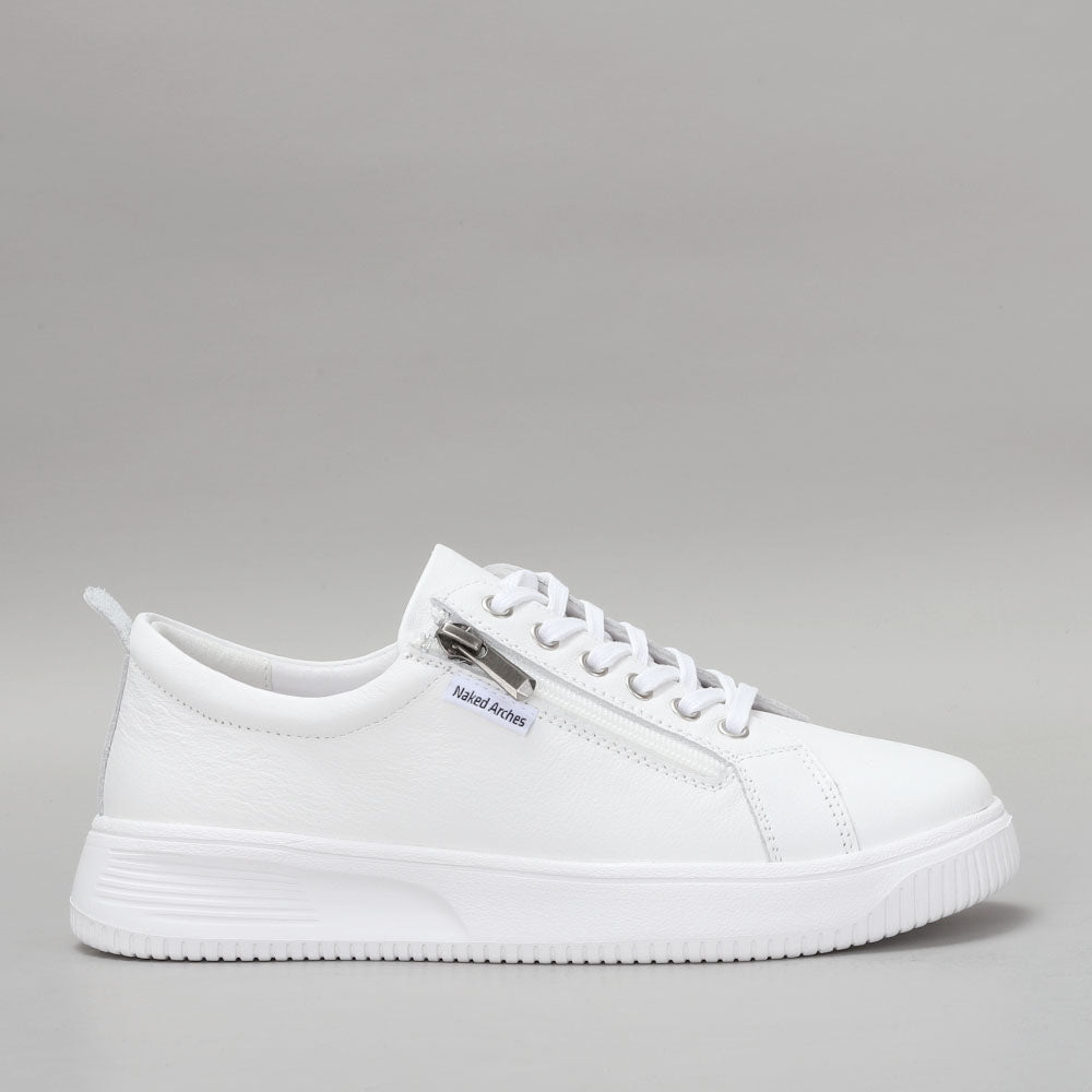 Naked Arches Nelly White sneakers with side view showing white canvas and rubber sole, stylish casual footwear.