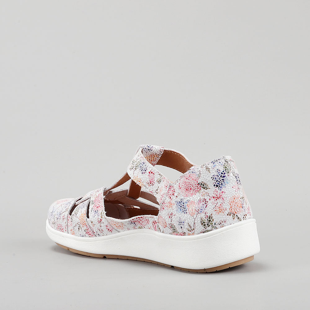 CC Resorts Nove White Floral casuals, featuring a white floral design, displayed on a model for a relaxed, summery look.