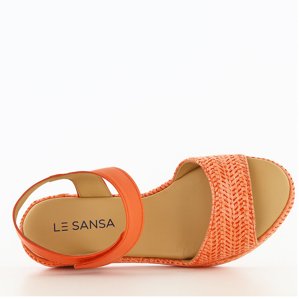 Le Sansa Pilia orange sandals with strappy design and flat sole, perfect for casual summer wear.