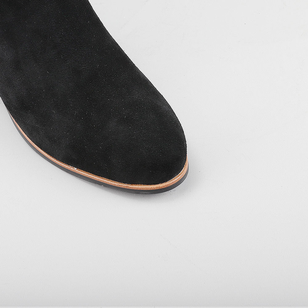 Close-up of Naked Arches Oxley black suede boots showing sleek design and smooth texture.