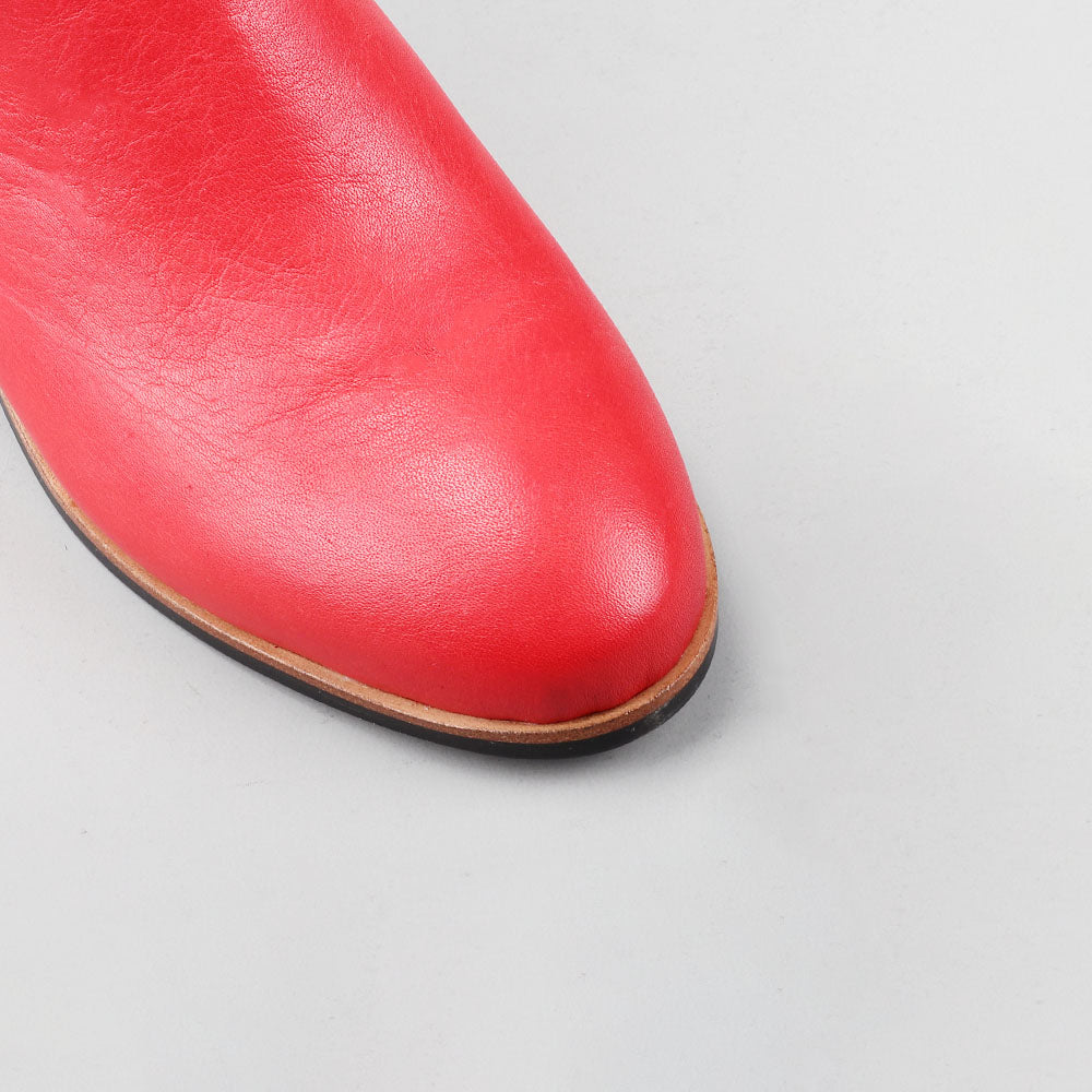 Close-up of Naked Arches Oxley Red boots showing the rich red leather and detailed stitching.