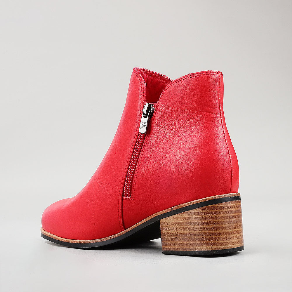 Naked Arches Oxley Red boots featuring sleek design and vibrant red color, displayed on a neutral background.