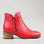 Naked Arches Oxley Red boots featuring a sleek red leather exterior and stylish ankle design.
