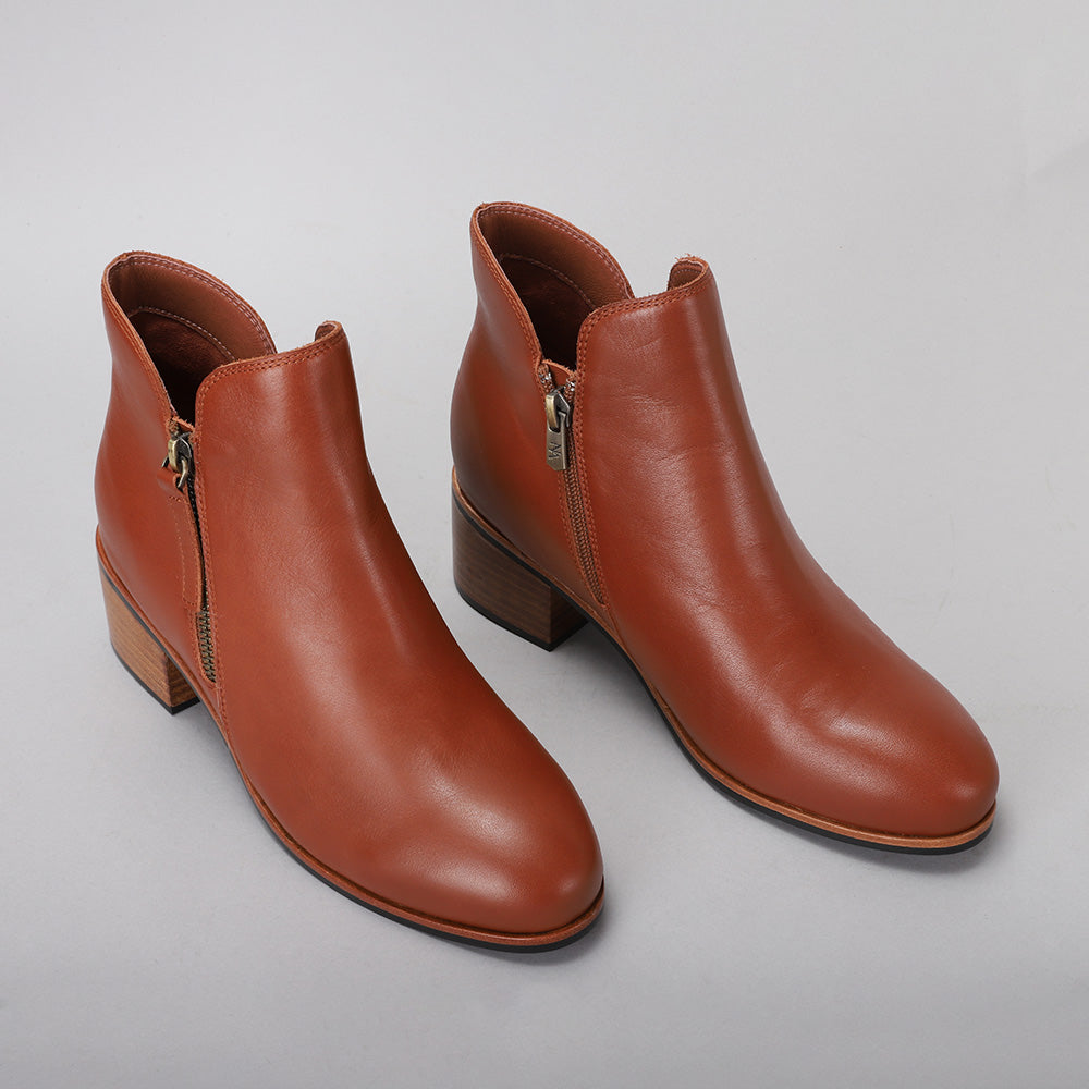 Pair of Naked Arches Oxley Cognac boots featuring smooth leather and stylish design, perfect for casual and formal wear.