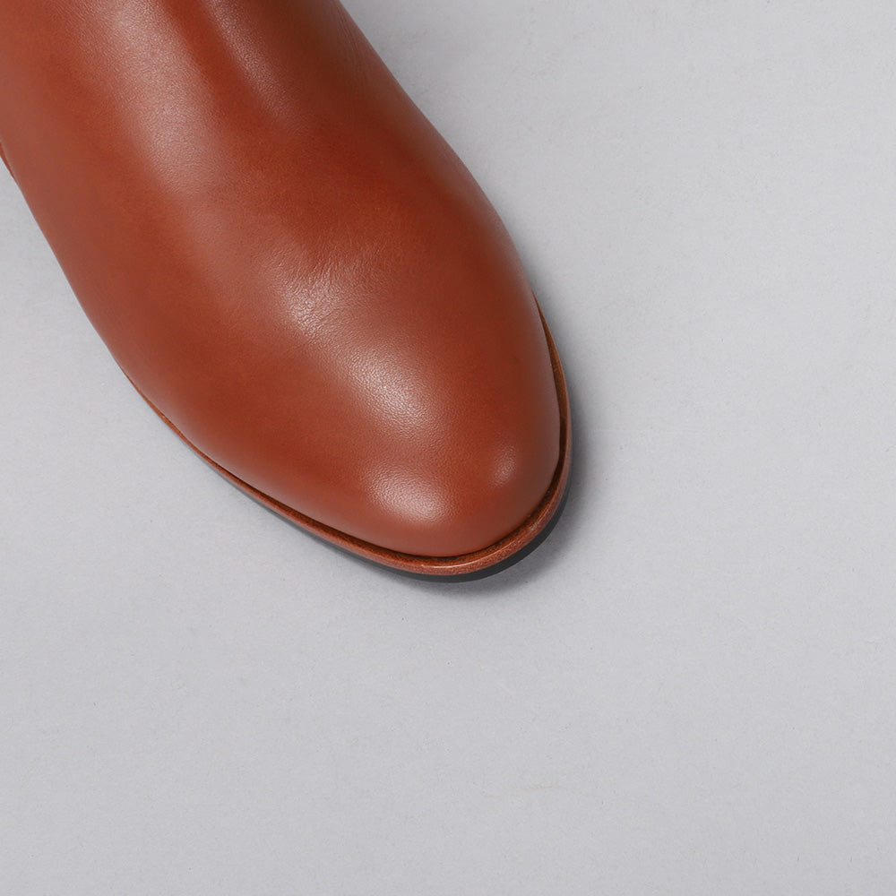 Naked Arches Oxley Cognac boots featuring smooth leather and stylish design, shown from the top view.