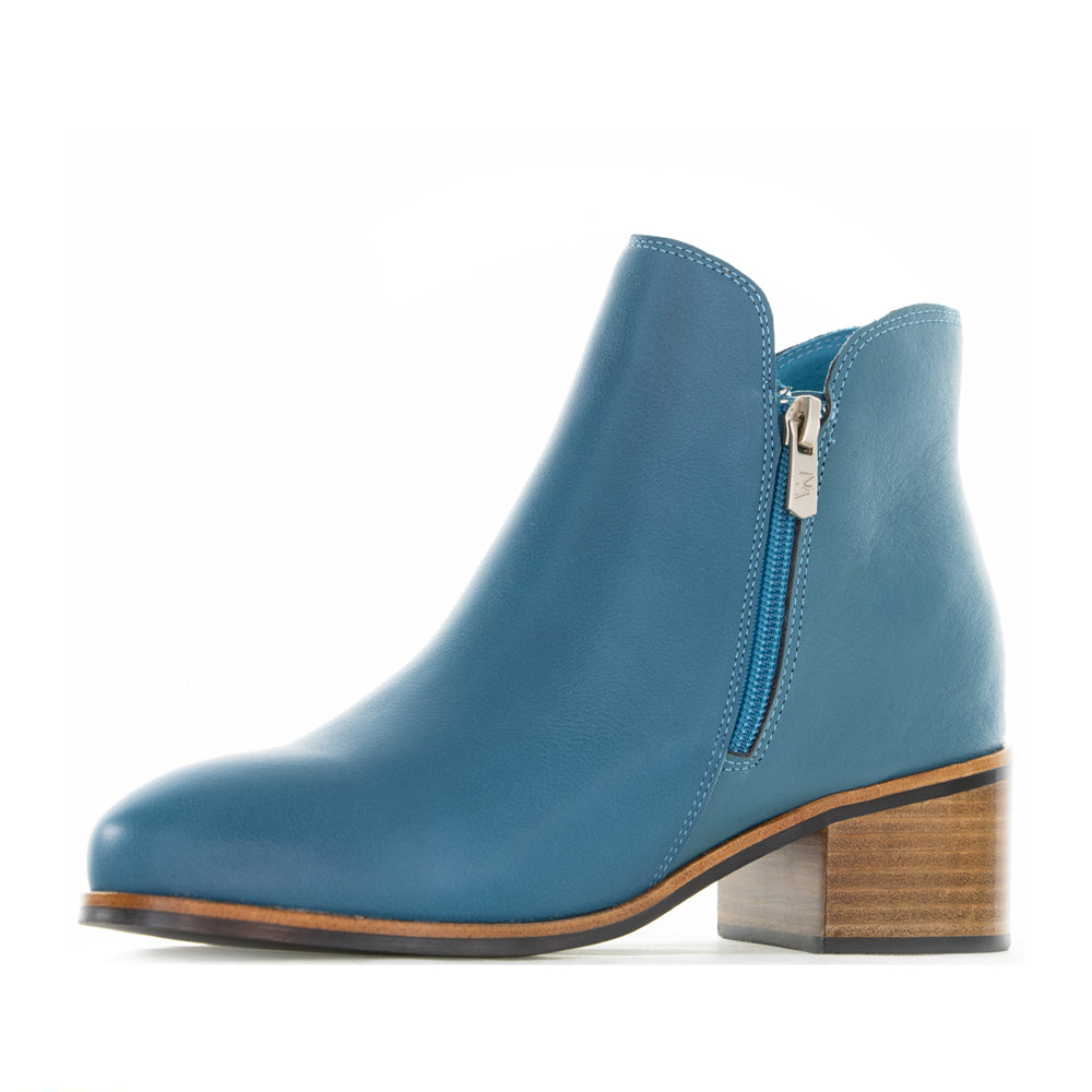 Naked Arches Oxley turquoise boots with ankle-high design and stylish stitching, featuring a pointed toe and textured sole.