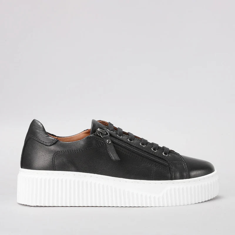 Le Sansa Palmer black sneakers shown from the side, featuring a sleek design and black leather upper with white sole detail.
