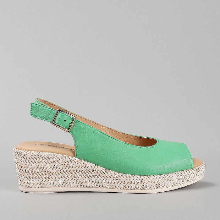 Le Sansa Petunia Fern Green sandals displayed, featuring open-toe design with green leather straps and casual style.