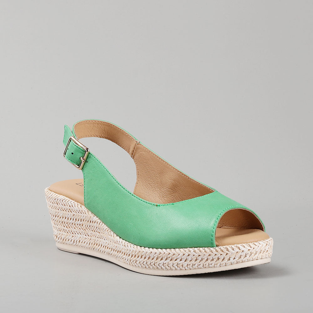 Le Sansa Petunia Fern Green sandals featuring stylish straps and a comfortable sole, perfect for casual summer wear.