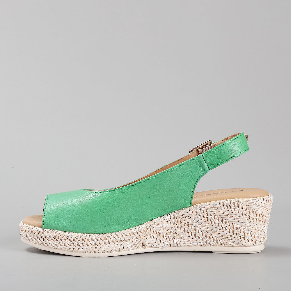 Le Sansa Petunia Fern Green sandals with woven straps and open toe design on a neutral background.