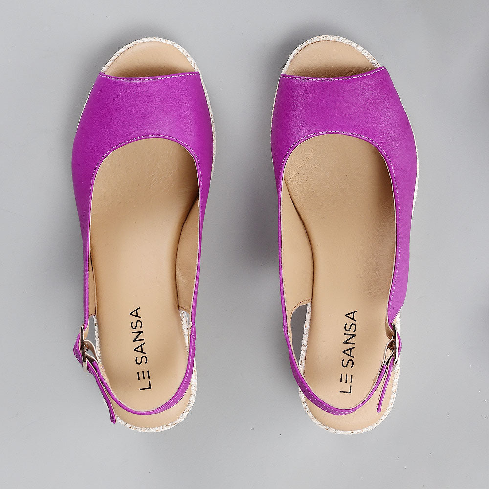 Pair of Le Sansa Petunia Purple sandals featuring open toes and ankle straps, displayed on a neutral background.