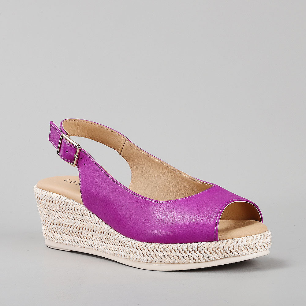 Le Sansa Petunia Purple sandals with open toes and ankle strap, featuring a vibrant purple color and stylish design.