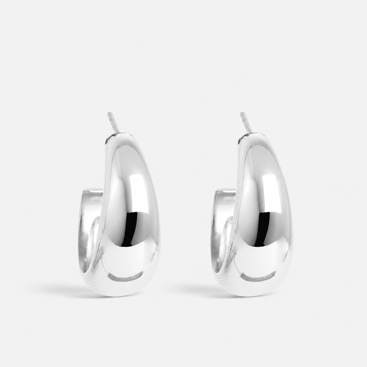 Silver soft steel earring by A & C Oslo, showcasing a sleek, minimalist design with a polished finish.
