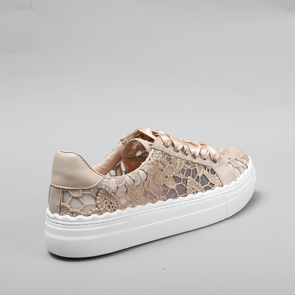 Le Sansa Quinn taupe sneakers with lace-up design and white soles, displayed on a neutral background.