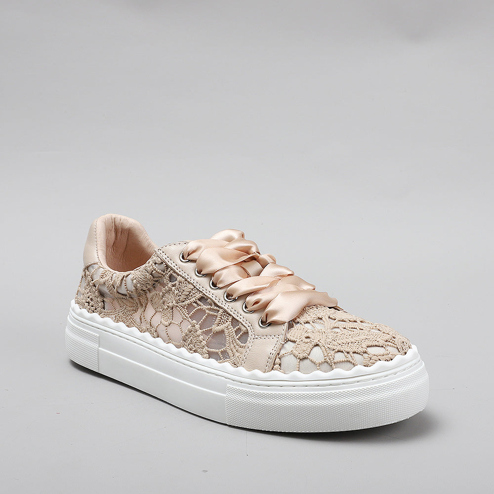 Le Sansa Quinn taupe sneakers with white soles and lace-up design, showcasing a stylish casual footwear look.