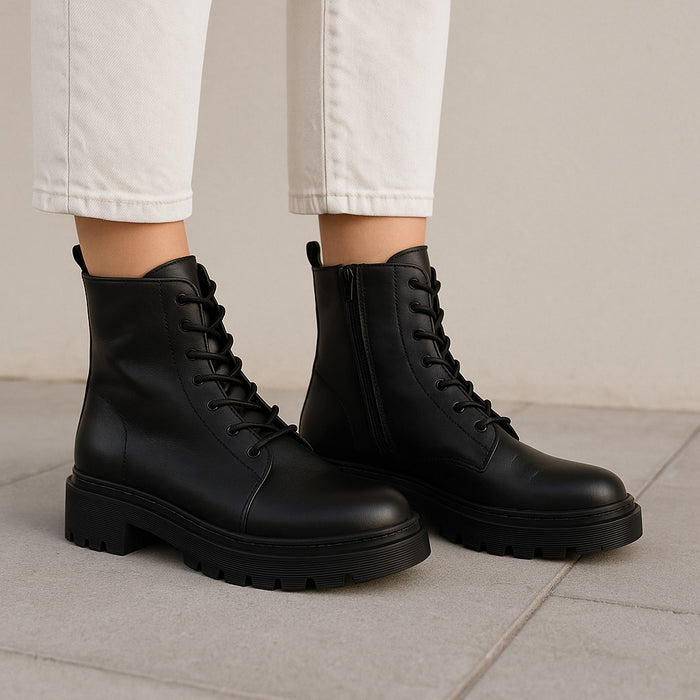 Black Le Sansa Lesansa Radiant boots with sleek design and pointed toes, showcasing stylish ankle-high footwear.