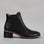 Black LE SANSA Refresh boots with sleek design and ankle-high fit, featuring smooth leather and subtle stitching details.