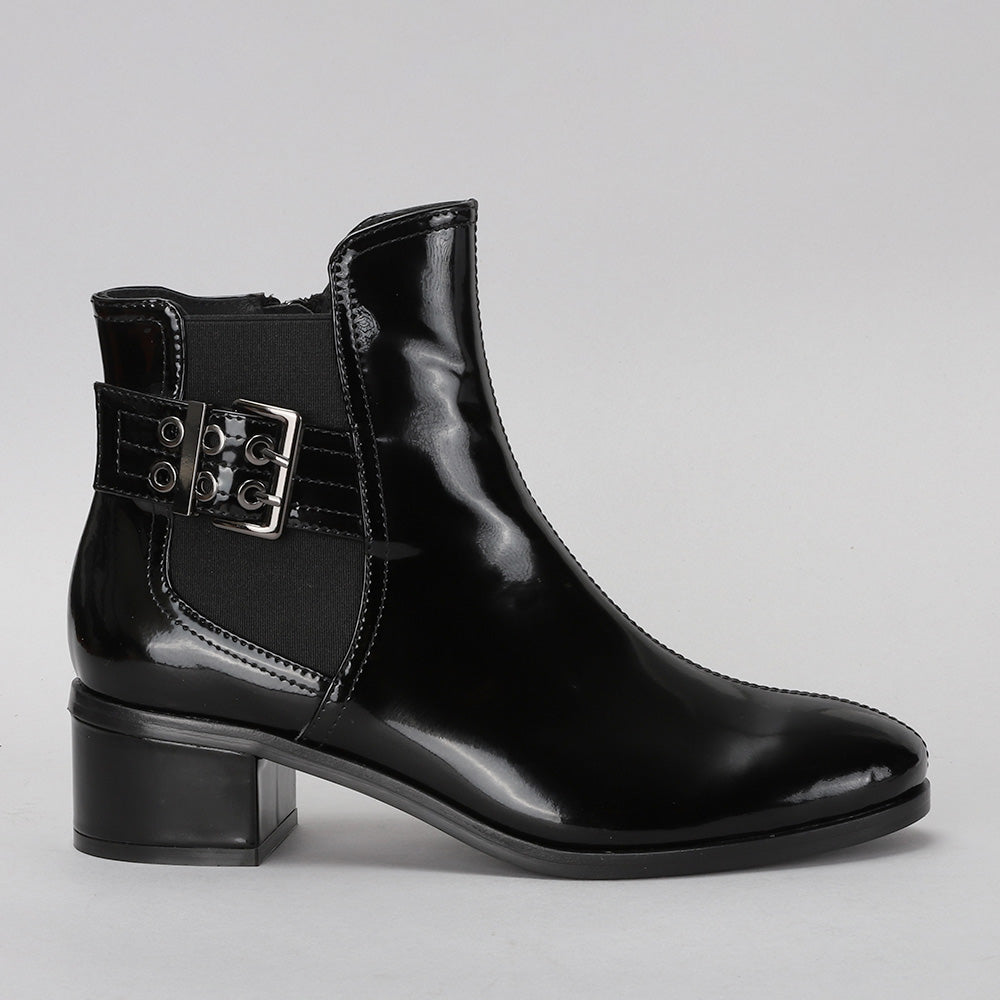 Le Sansa Romy black leather boots viewed from the side, showcasing sleek design and ankle height.