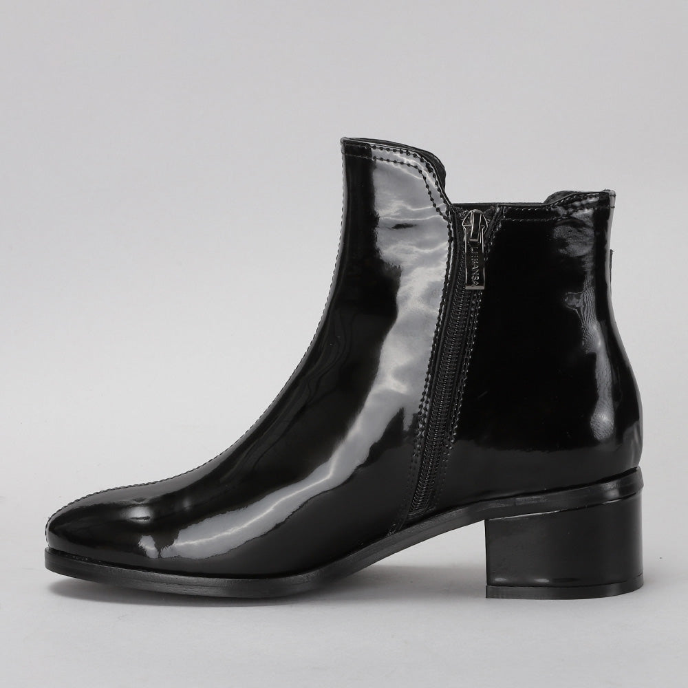 Black LE SANSA ROMY patent leather boots with sleek design and pointed toes, stylish footwear for versatile wear.