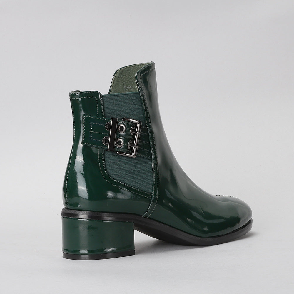 Le Sansa Romy green boots displayed on a model, featuring stylish ankle-high design with sleek leather and modern details.