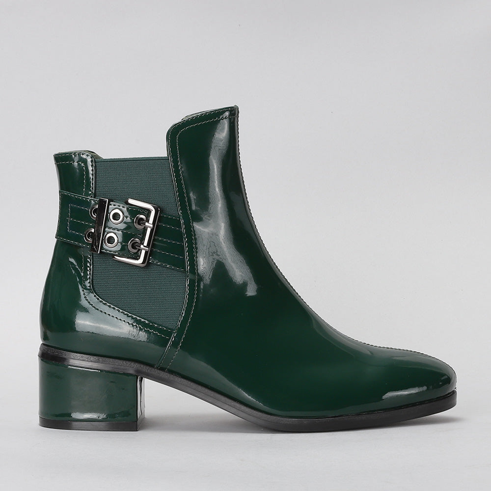 Le Sansa Romy green boots shown from a side view, featuring a sleek design and vibrant green color.