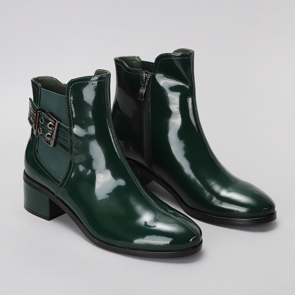 Pair of Le Sansa Romy green boots with sleek design and stylish ankle height, perfect for casual or trendy outfits.