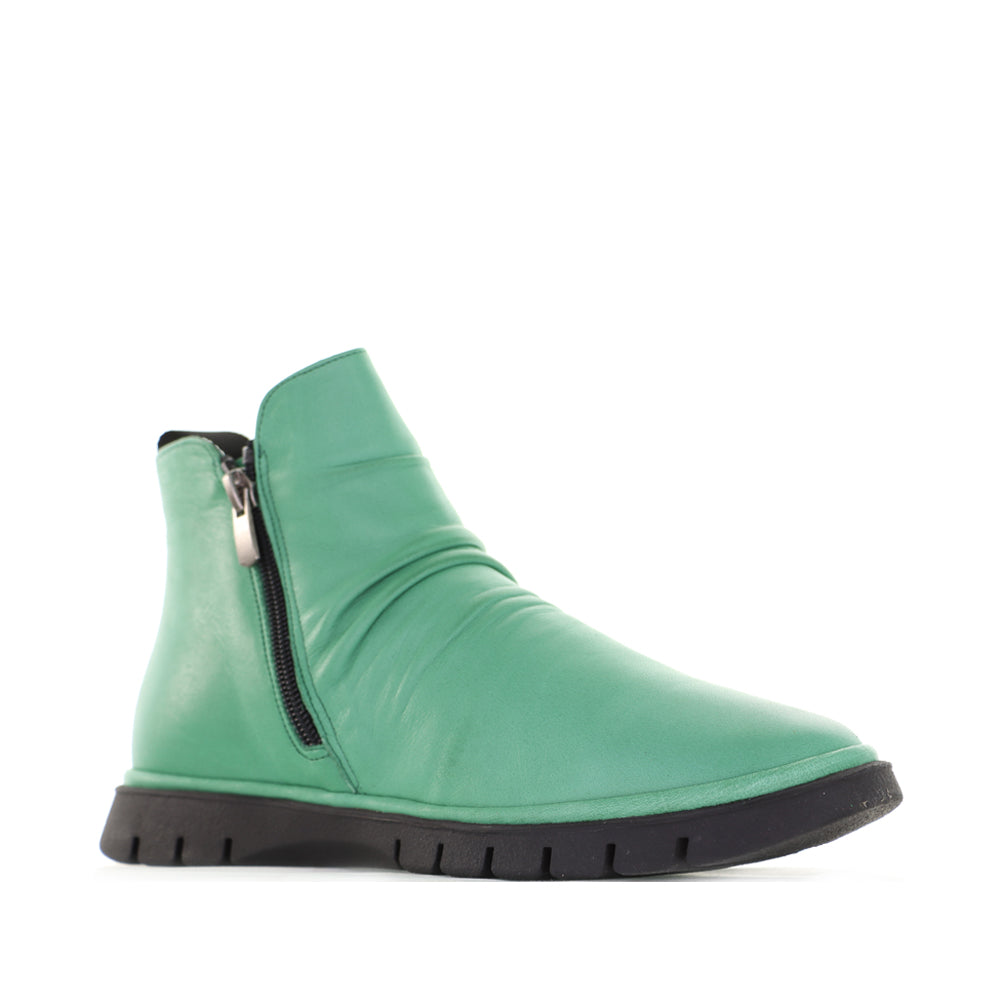 Le Sansa Rubel Jade boots in vibrant green leather with stylish ankle design and decorative stitching.
