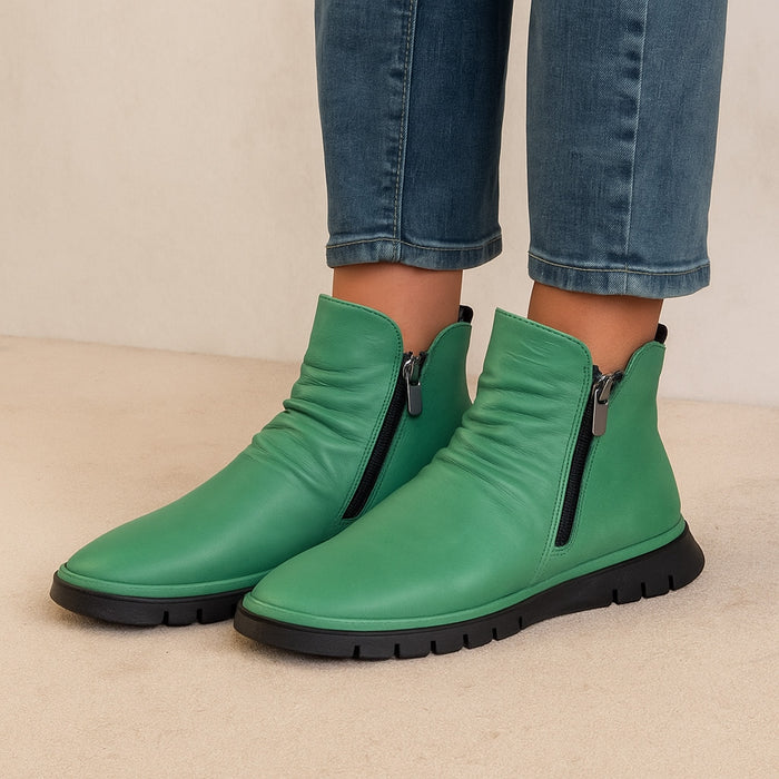 Le Sansa Rubel Jade boots featuring stylish design and comfort, shown in a close-up image highlighting the vibrant color and details.