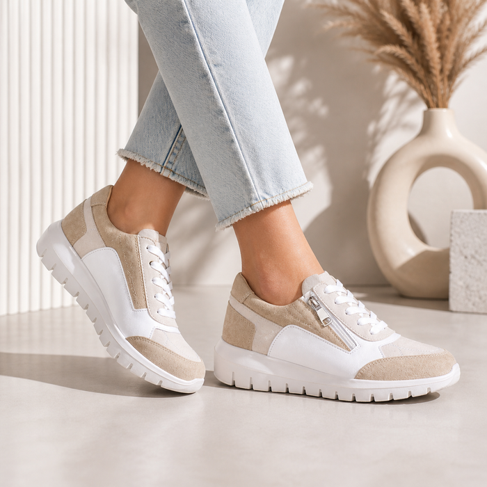 Le Sansa Ryder white blush sneakers with sleek design and white and blush accents, showcased from a side angle.