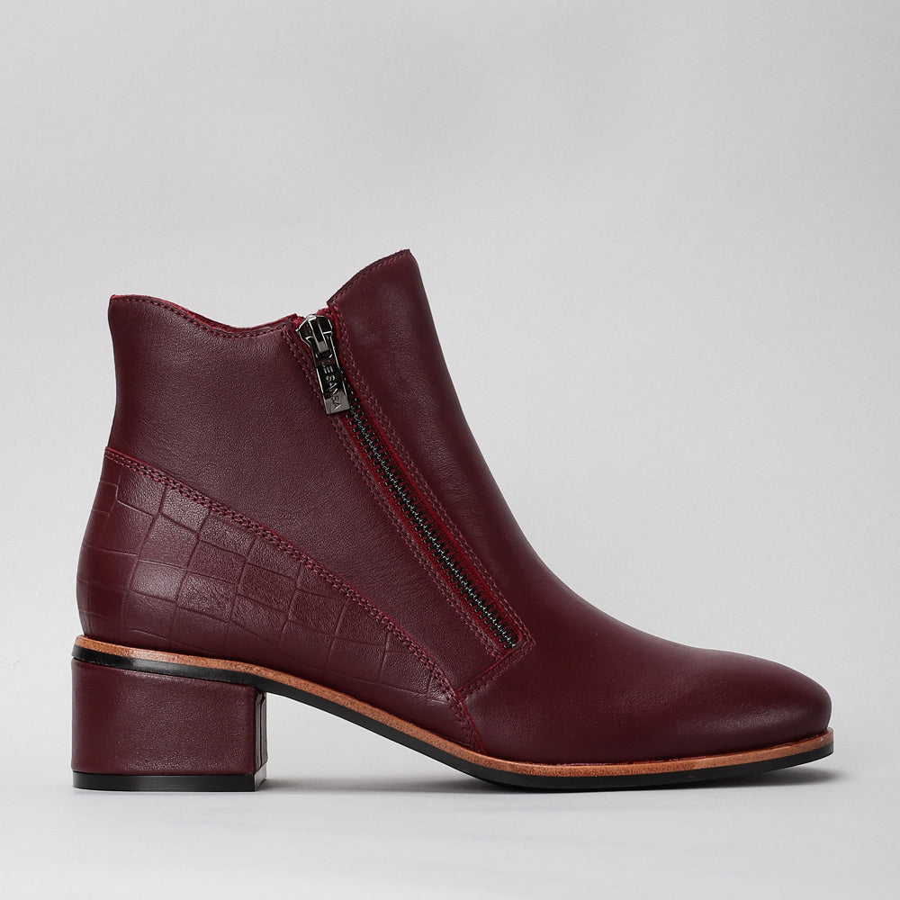 LE SANSA Refine Merlot Patent boots showcasing sleek maroon leather with a polished, stylish design.