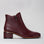 Le Sansa Refine Merlot Patent boots showing glossy maroon leather with sleek design and pointed toes.