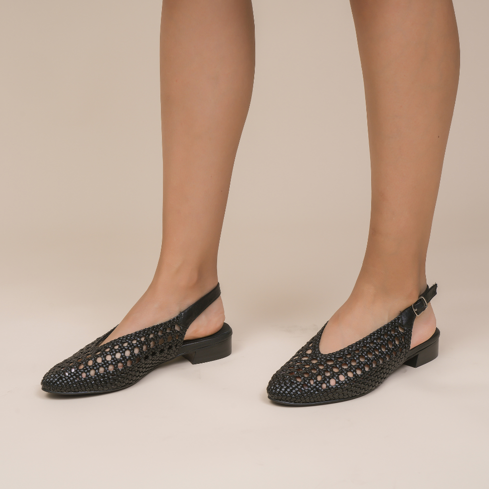 Black Le Sansa Camila sandals with ankle straps and open toes, displayed on a neutral background.