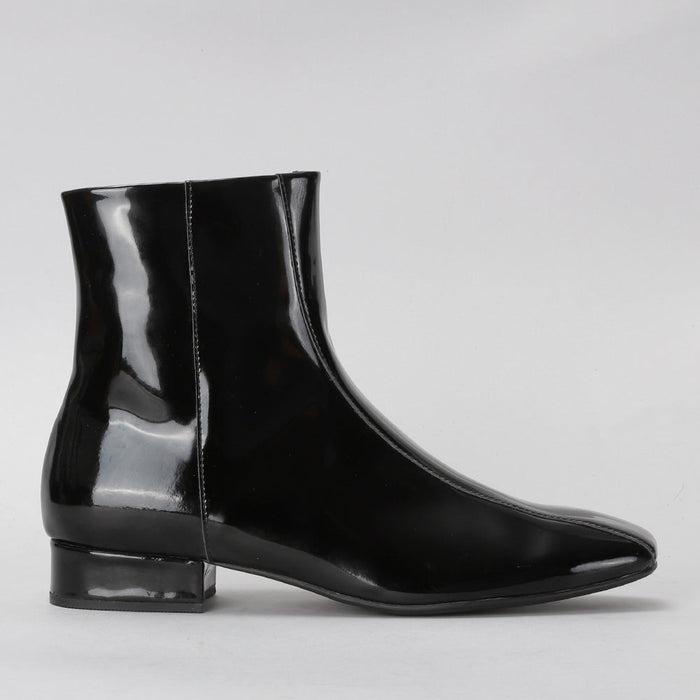 Le Sansa Sasha black patent boots showing side view, sleek shiny finish, ankle height, and stylish design.