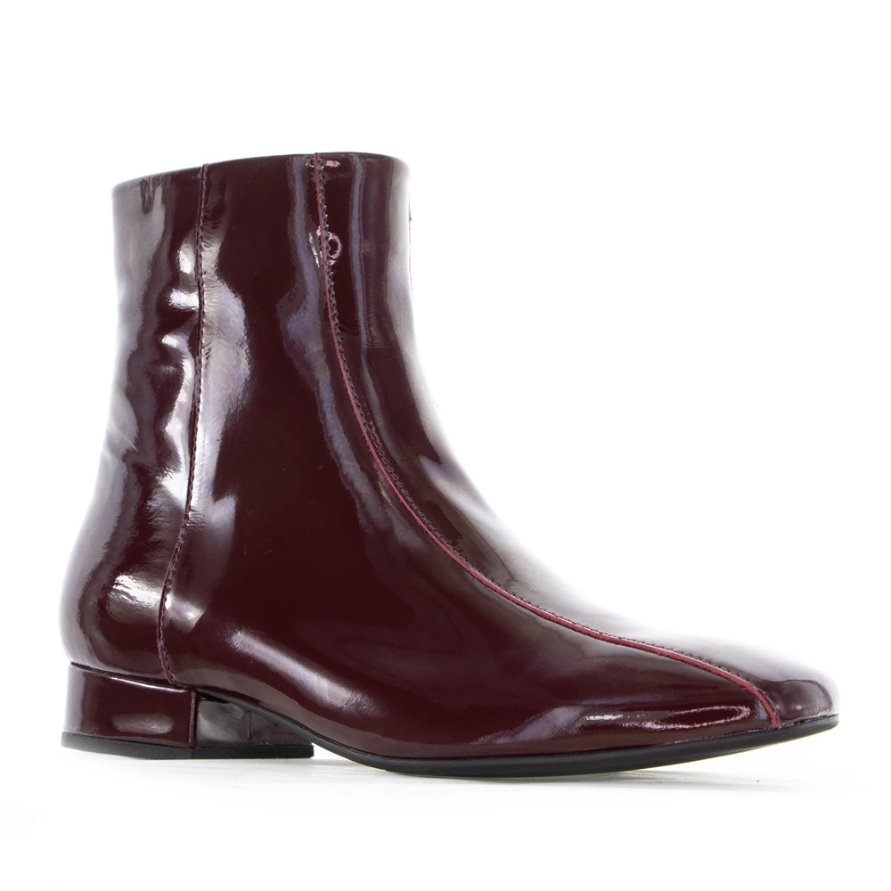 Le Sansa Sasha Merlot Patent Boots featuring sleek red patent leather and stylish ankle-height design.