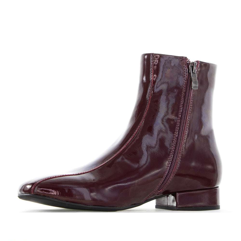 Le Sansa Sasha Merlot Patent Boots with sleek design and shiny red finish, stylish footwear for everyday wear.