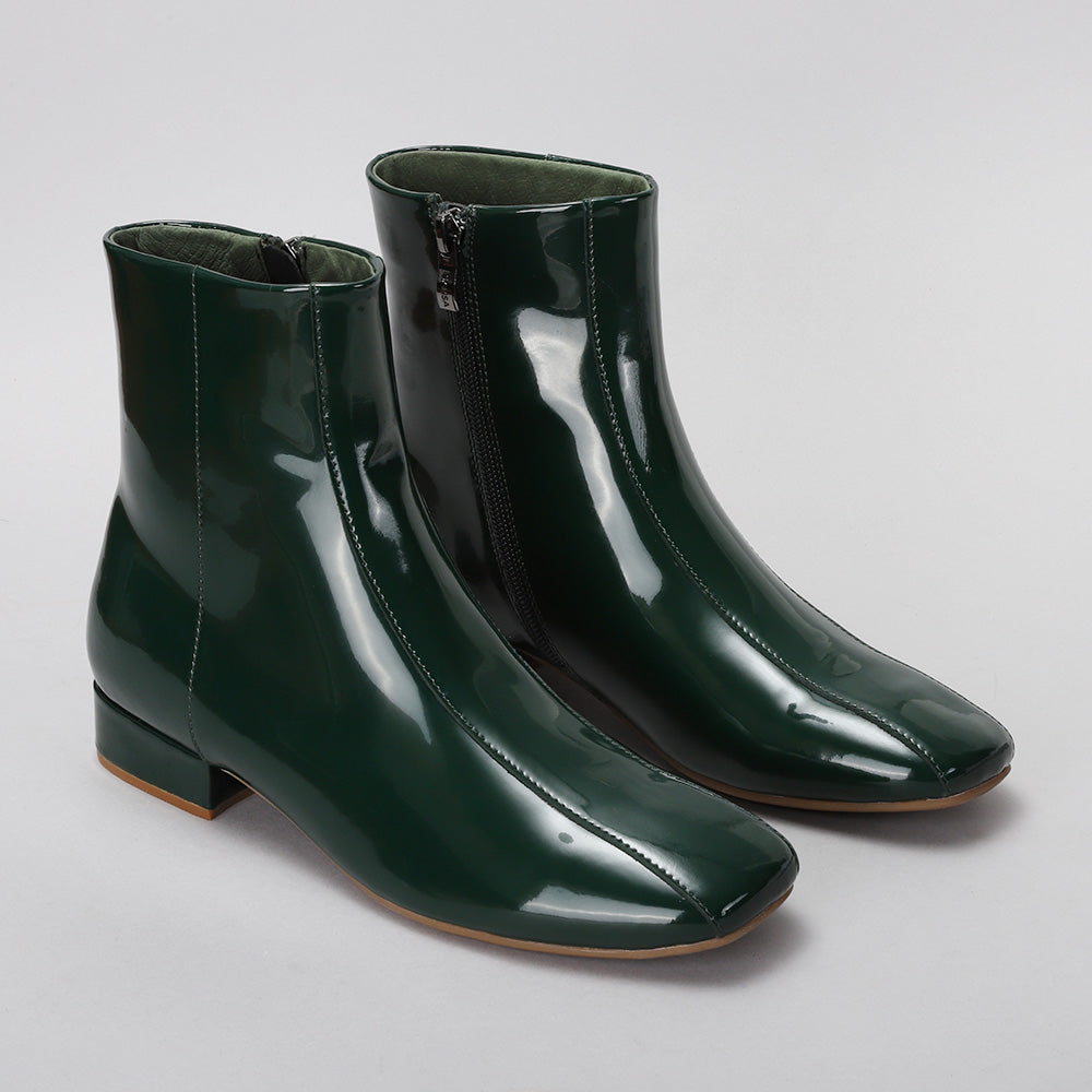 Pair of green Sasha boots by Le Sansa, featuring stylish design and sturdy soles, shown from the front angle.