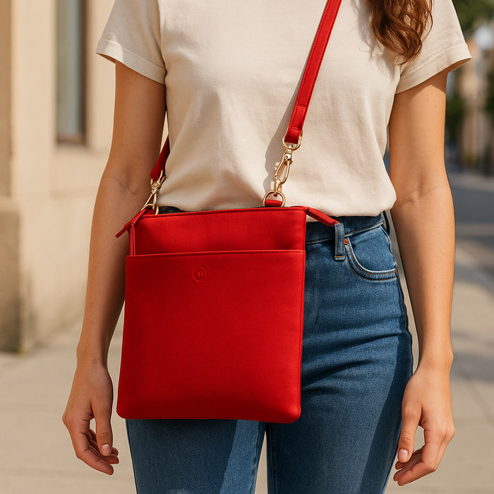 Red Second Nature handbag with sleek design and structured shape, featuring top handles and subtle branding.
