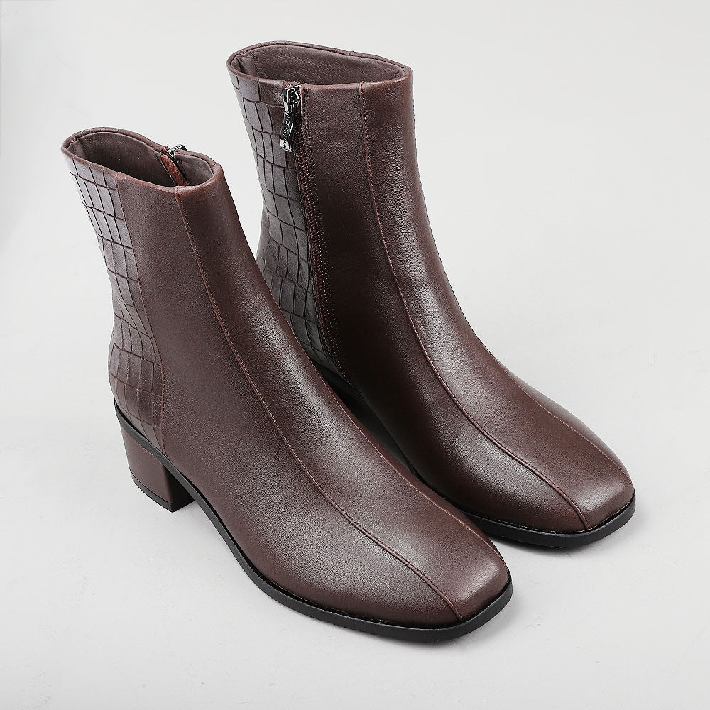 Le Sansa Spike Choco boots with chocolate-colored crocodile print, stylish and textured footwear for casual or trendy outfits.