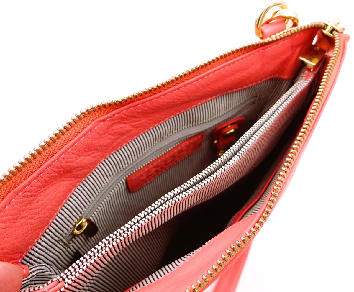 Second Nature Coral Flame handbag with textured material and stylish design, featuring a vibrant coral color and elegant shape.