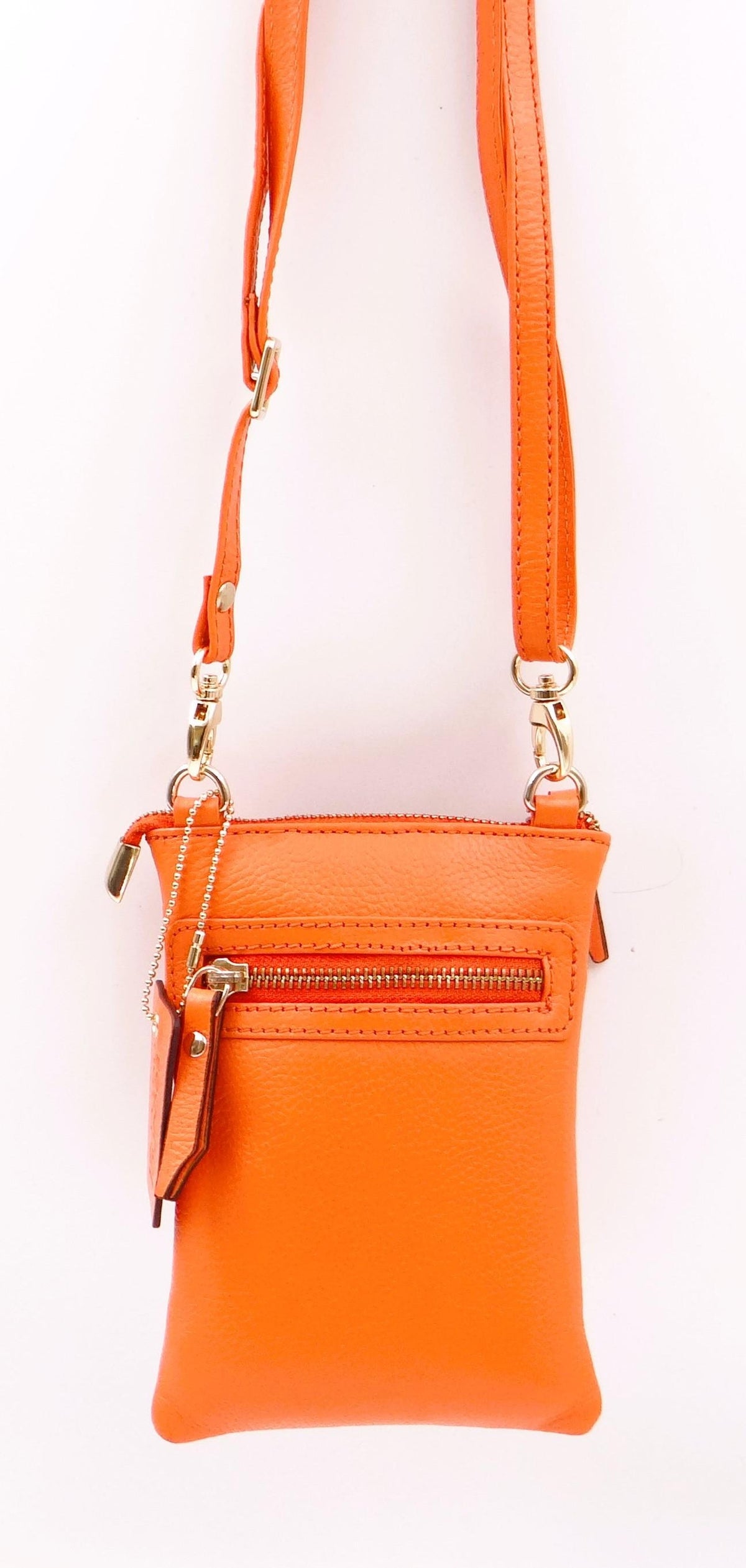 Second Nature orange handbag with sleek design, featuring a structured shape and top handle, on a neutral background.