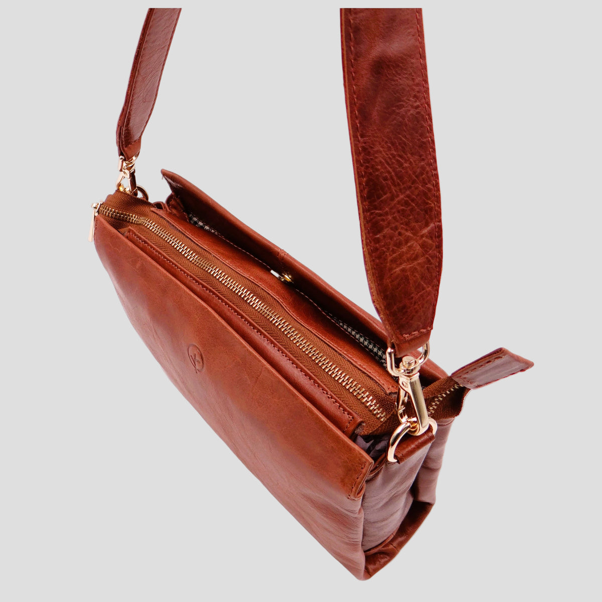 Second Nature ST82 tan handbag with sleek design and structured shape, featuring top handles and subtle stitching details.