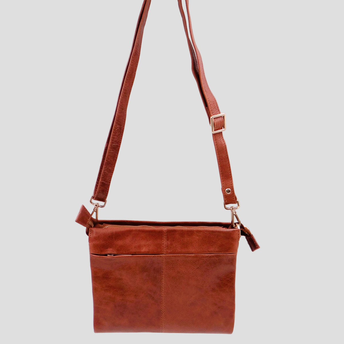 Tan Second Nature Second Nature ST82 handbag with sleek design and gold-tone hardware, shown from a front view.