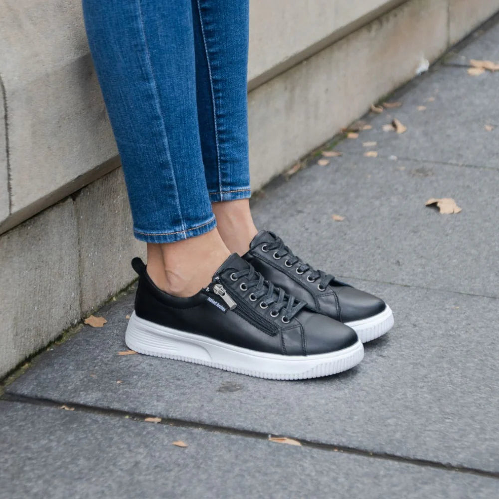 Black Naked Arches Nelly sneakers with sleek design and minimal branding, featuring comfortable laces and stylish silhouette.