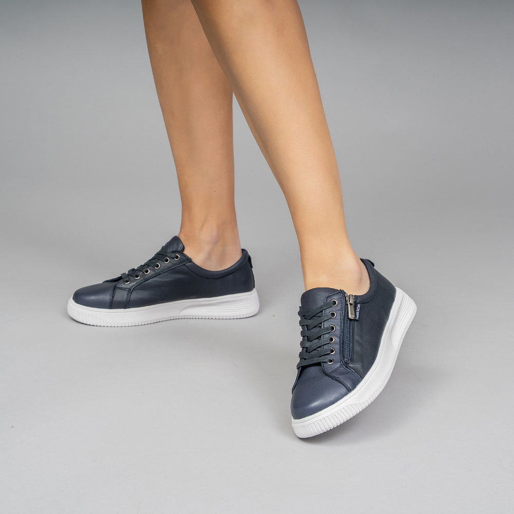 Naked Arches Nelly Navy sneakers showing navy blue canvas uppers with white rubber soles and laces.
