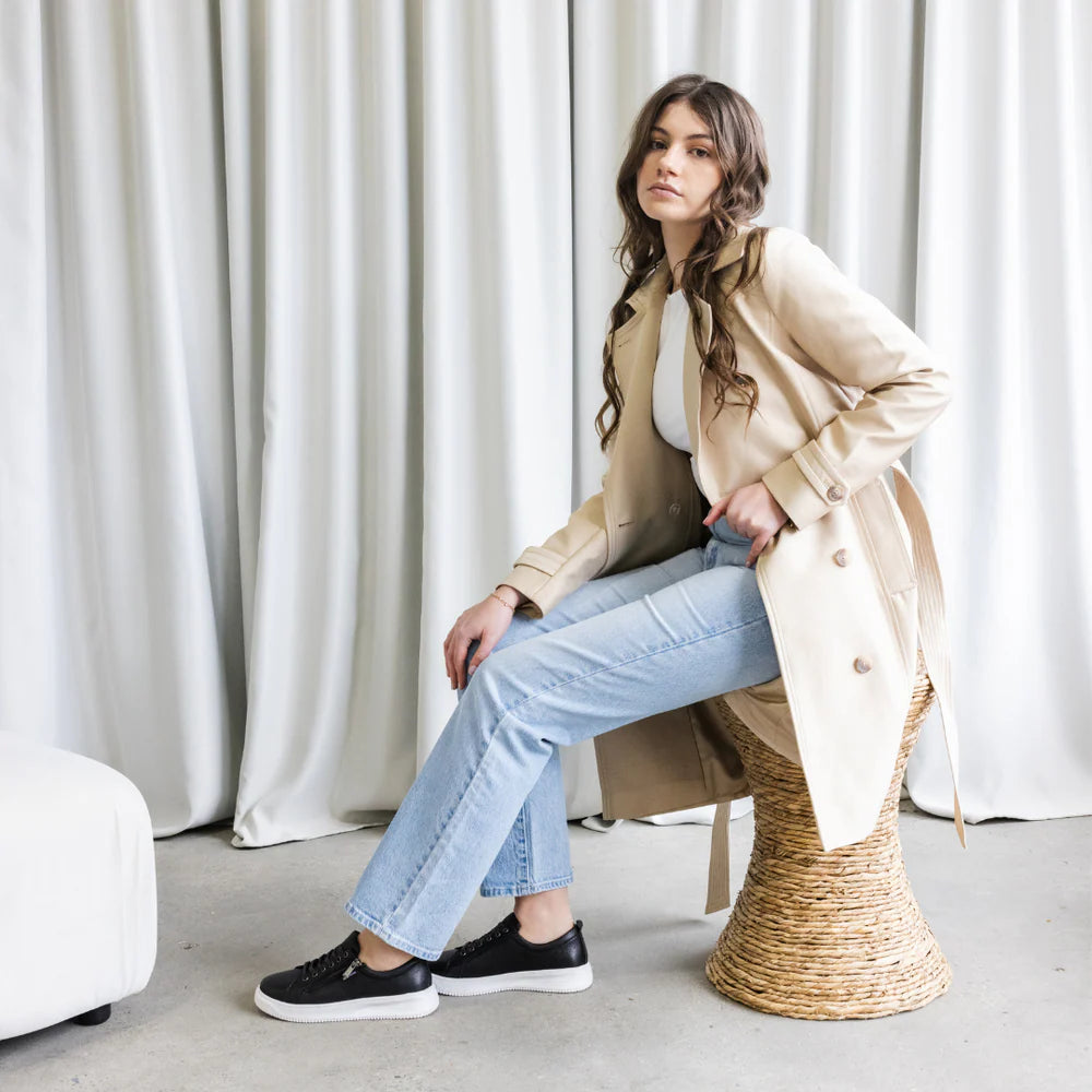 Black NAKED ARCHES NELLY sneakers with sleek design and white sole, displayed on a plain background.