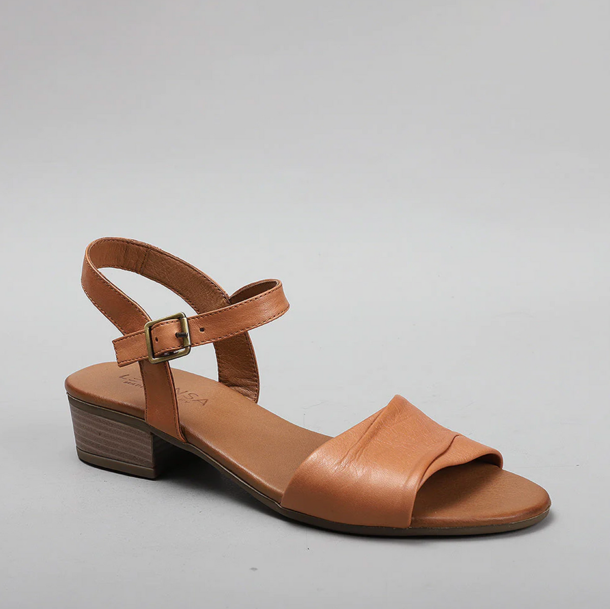 Le Sansa Lesansa Delta Tan sandals with open toes and adjustable straps, featuring a tan leather finish and comfortable sole.
